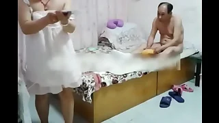Chinese woman and her guy at the tourist house